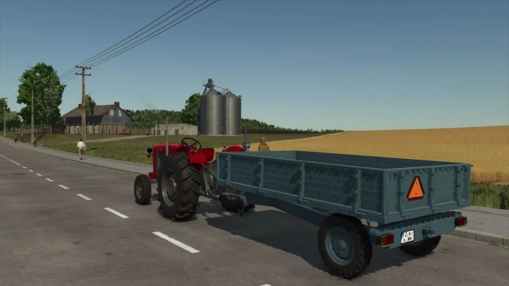 fs25-mods,  FS25 Loznica 5T mod showcasing a red tractor with a blue trailer on a rural road.