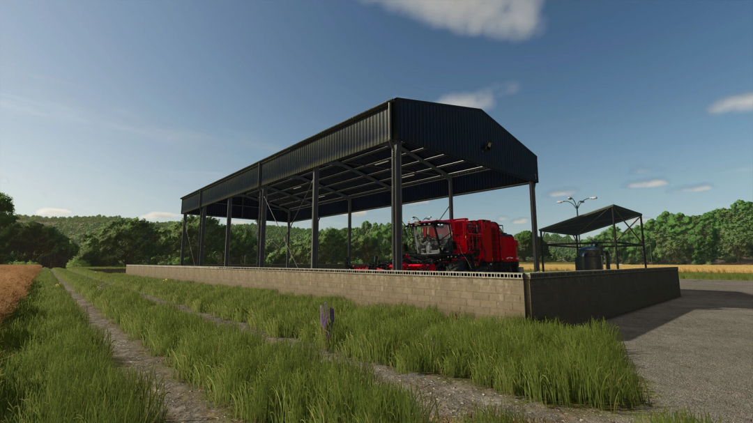 Awning Tubers mod in FS25 showing a shelter with a red harvester and equipment, surrounded by green fields.