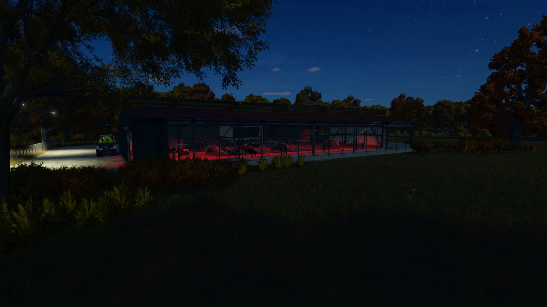 Night view of Cow Barn Big with LIZARD Mixfeeder in FS25 mod, illuminated by red lights.