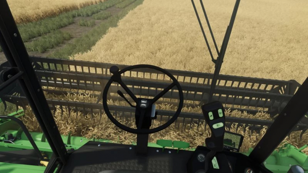 Interior view of Deutz-Fahr M series harvester in FS25 mod, showing steering and control panel while harvesting wheat.