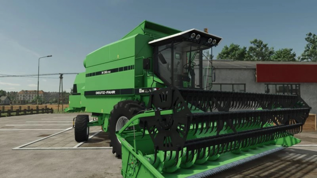 Deutz-Fahr M series harvester in FS25 mod pack, parked near a building.