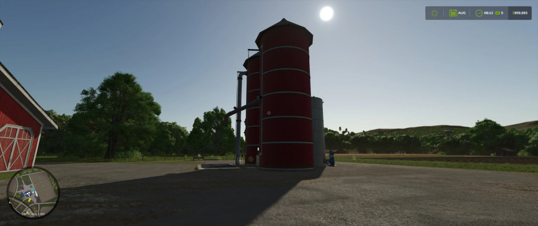 FS25 Fermenting Silo v1.0.0.0 mod in Farming Simulator 25. Red silo under clear sky, surrounded by trees.