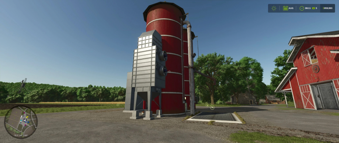 FS25 Fermenting Silo mod in Farming Simulator 25, red silo on farm with clear sky.