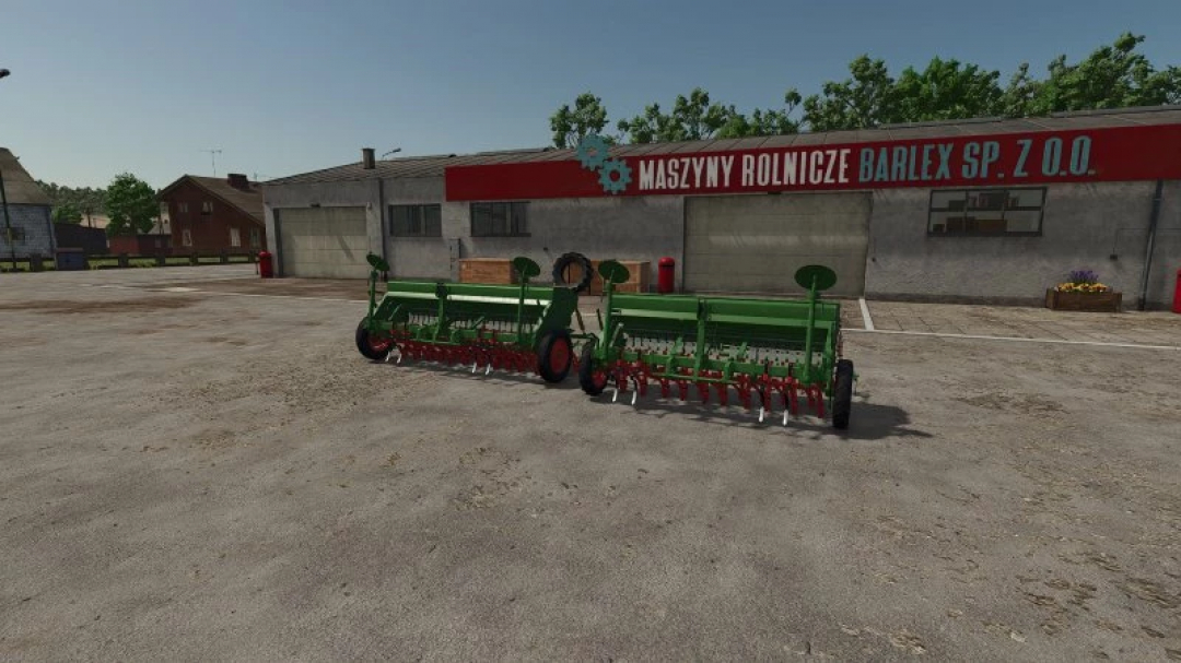 FS25 Hassia pack v1.0.0.0 mod showing two green seeders in front of a farming building. Ideal for Farming Simulator 25 game.