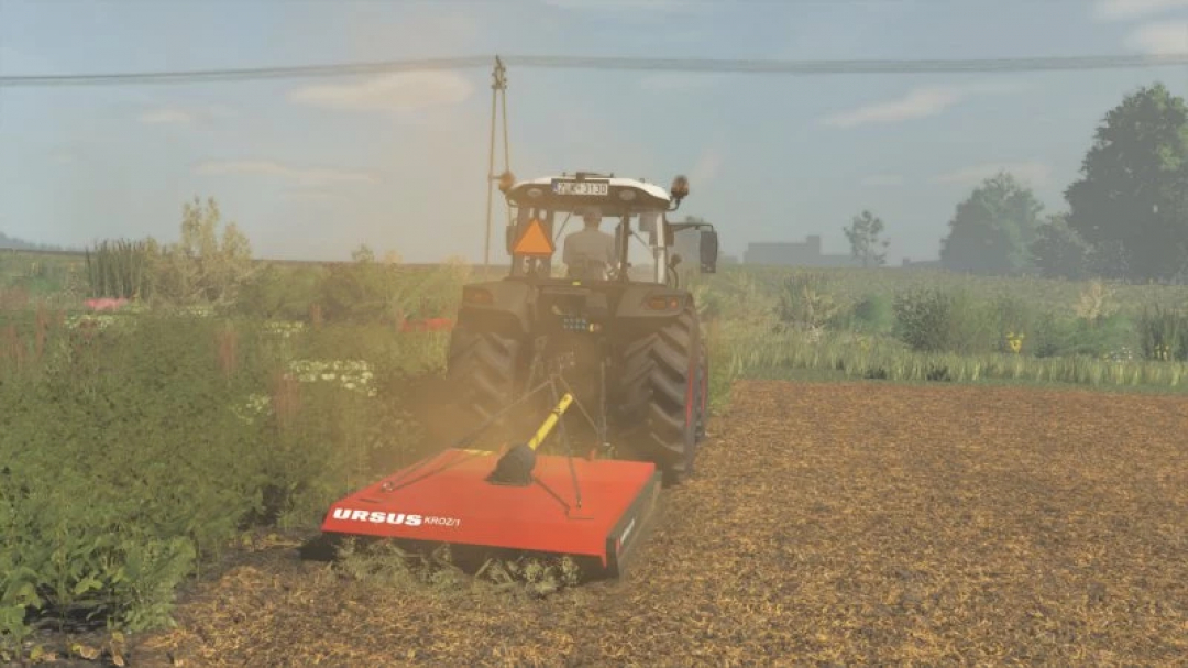 FS25 Ursus KROZ/1 mod in Farming Simulator 25, featuring a tractor with a red mower attachment in a field.