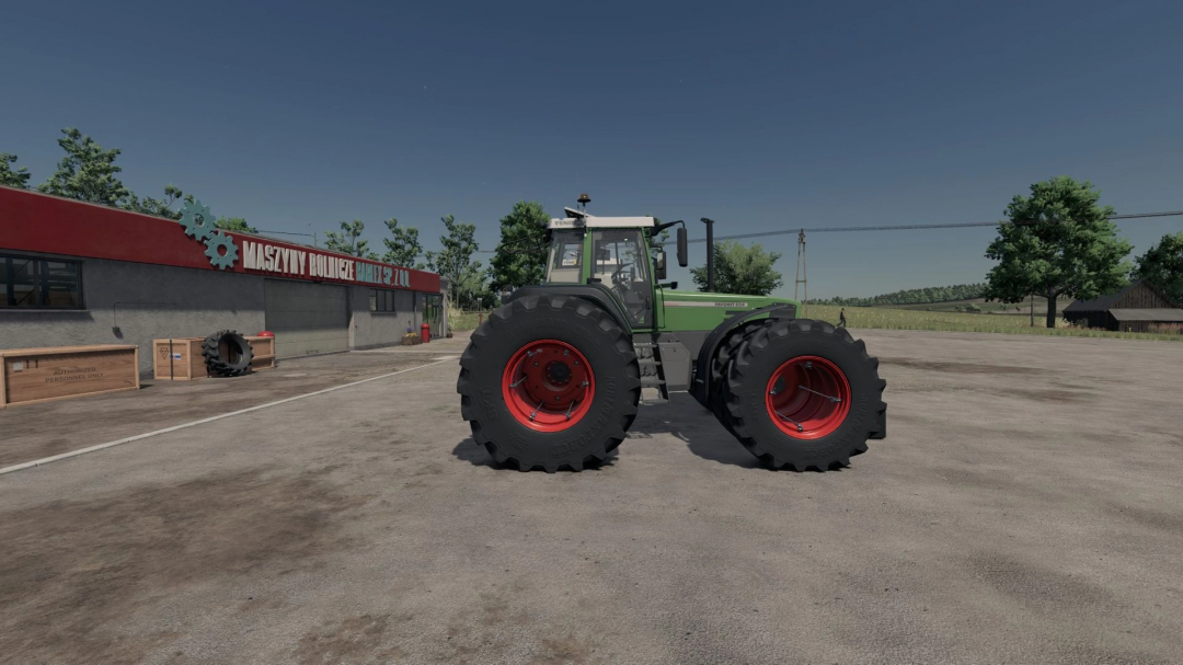 Fendt Favorit 800 LSE tractor mod in FS25 near a building with crates, showcasing dual rear wheels.