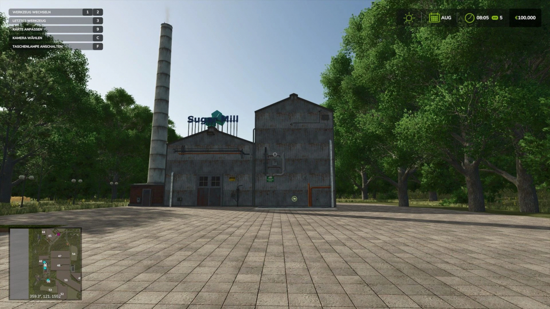 FS25 mod HermannsEck v1.1.0.0 showing a sugar mill with a tall chimney, surrounded by trees.