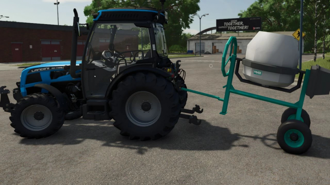 FS25 mods: IMER concrete mixer v1.0.0.0 attached to a tractor in Farming Simulator 25.