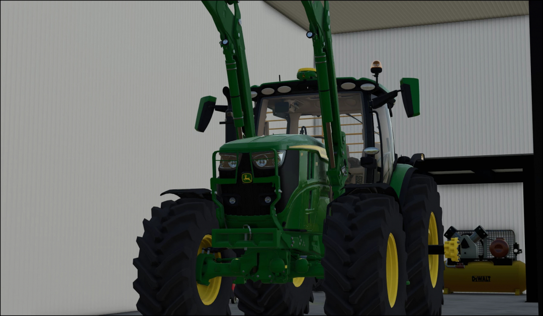 FS25 mod John Deere 6R US v1.0.0.0 tractor in shop, featuring front loaders.