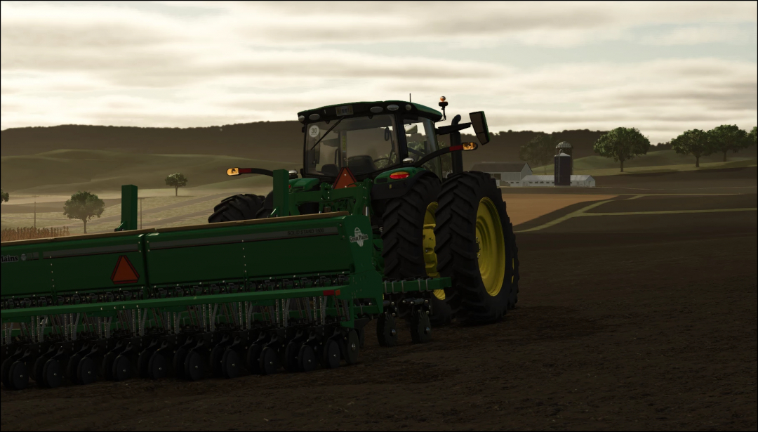 John Deere 6R US mod in Farming Simulator 25, featuring a tractor working in the fields during sunset.