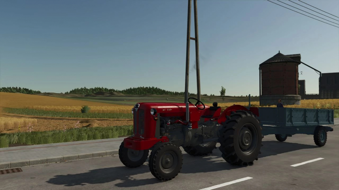 Loznica 5T mod for Farming Simulator 25, featuring a red tractor with a trailer on a rural road.