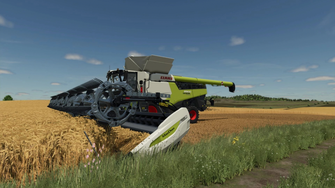 FS25 mod MacDon FD250 Claas Edition harvesting in a wheat field.