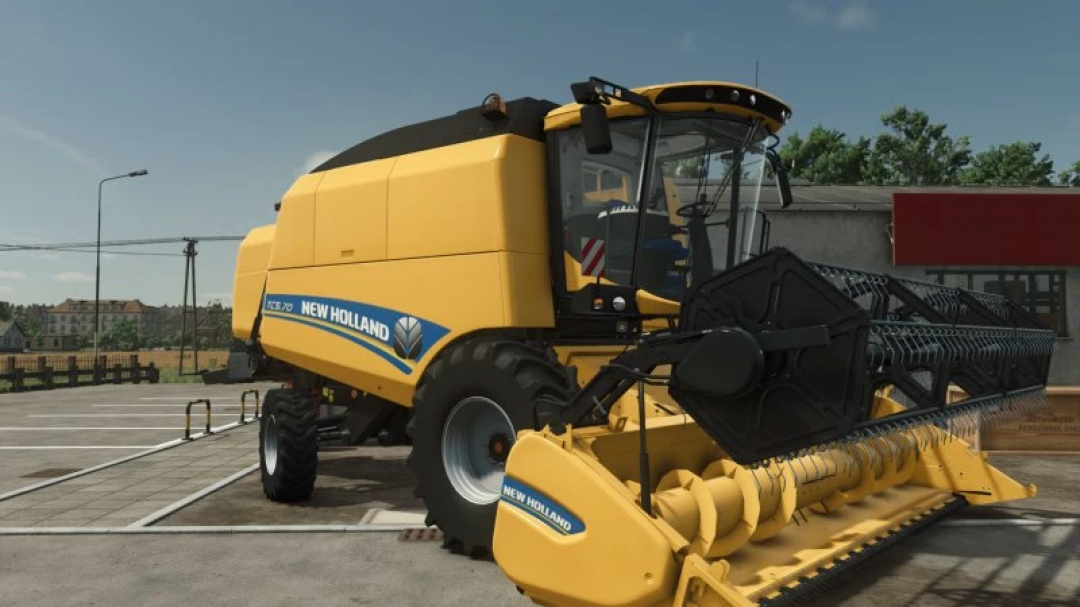 New Holland TC5 Series harvester mod for FS25 parked outside a building.