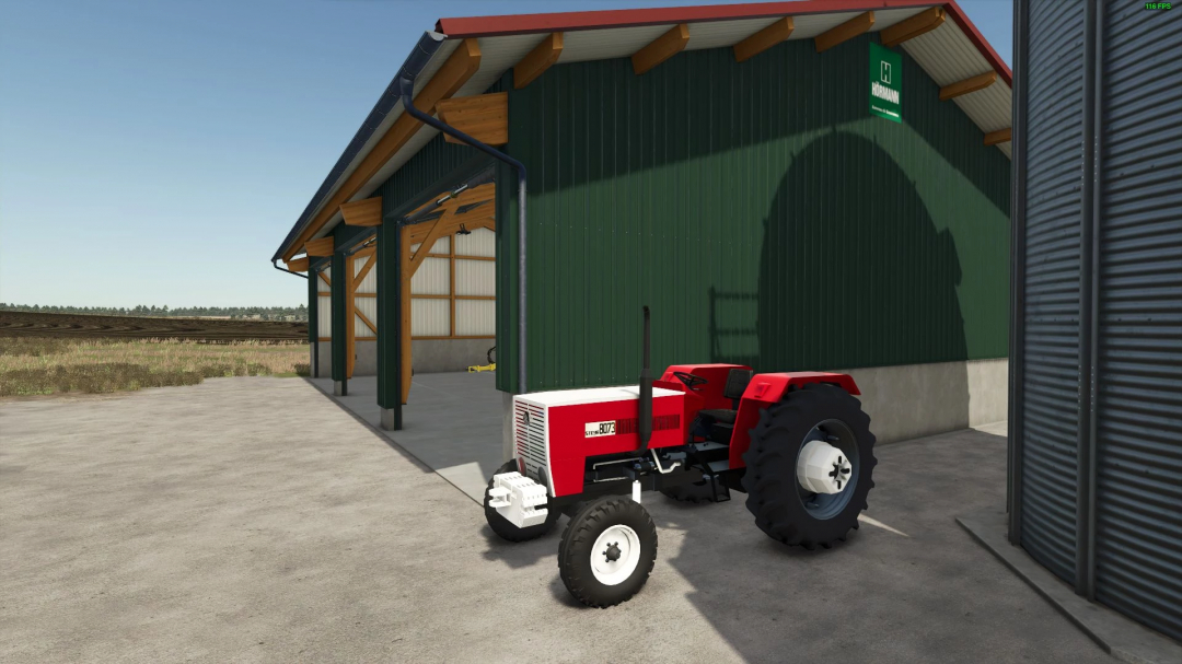 Steyr 8073 mod for Farming Simulator 25 parked by a green barn. FS25 mods enhance gameplay.