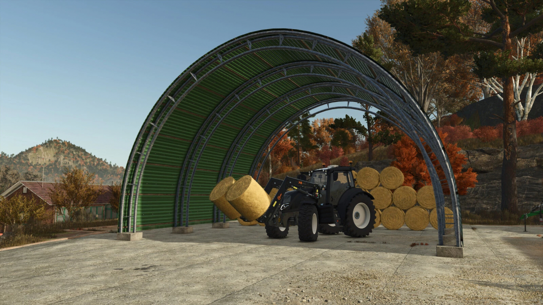 Tractor loading hay bales in green storage tunnel in FS25 mod.