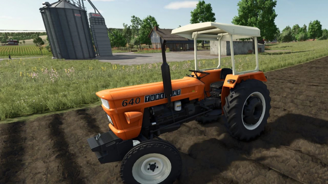 FS25 mod Turkish Fiat tractor v1.0.0.0 on farmland, featuring an orange design with canopy.