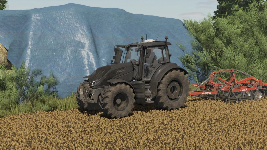 FS25 mod: Unia Cross L Drive v1.0.0.0, a black tractor with a plow in a field, Farming Simulator 25 scene