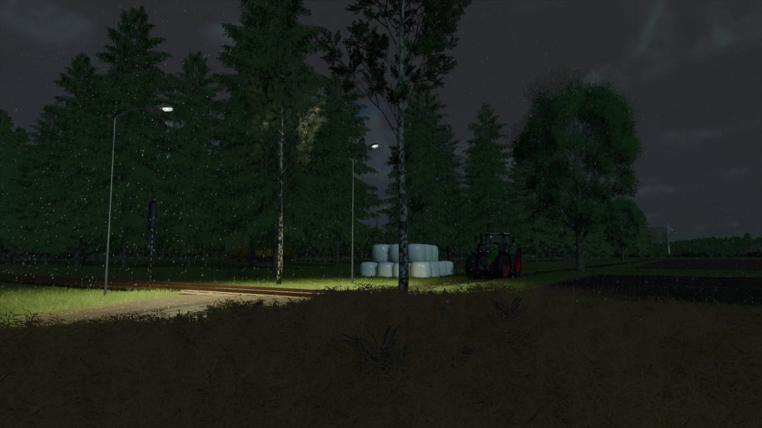 Night scene in FS25 mod Warminska Dolina with tractor and hay bales near forest under streetlights.