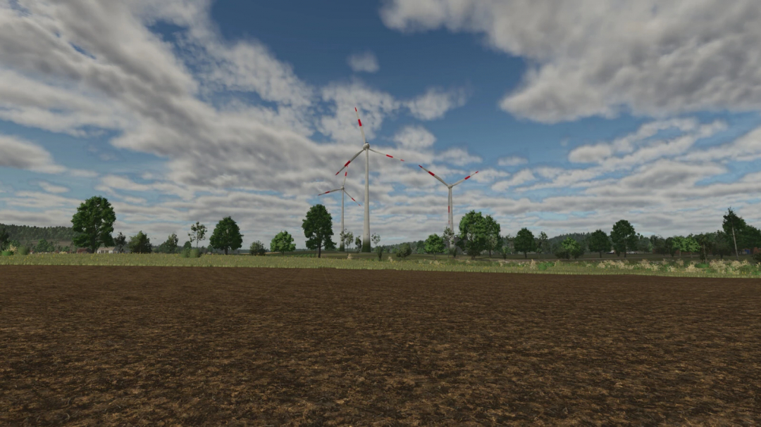 Wind turbines in a field with trees in Farming Simulator 25, showcasing the Wind Turbine Package v1.0.0.0 mod.