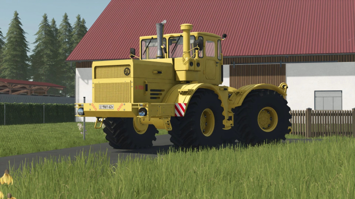 fs25-mods,  Kirovets K-700A tractor mod in FS25 near a barn, showcasing its large yellow design.