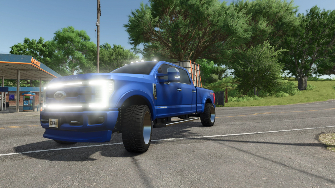 2019 F250 Limited v1.0.0.1 mod in FS25, blue truck on a rural road near a gas station.