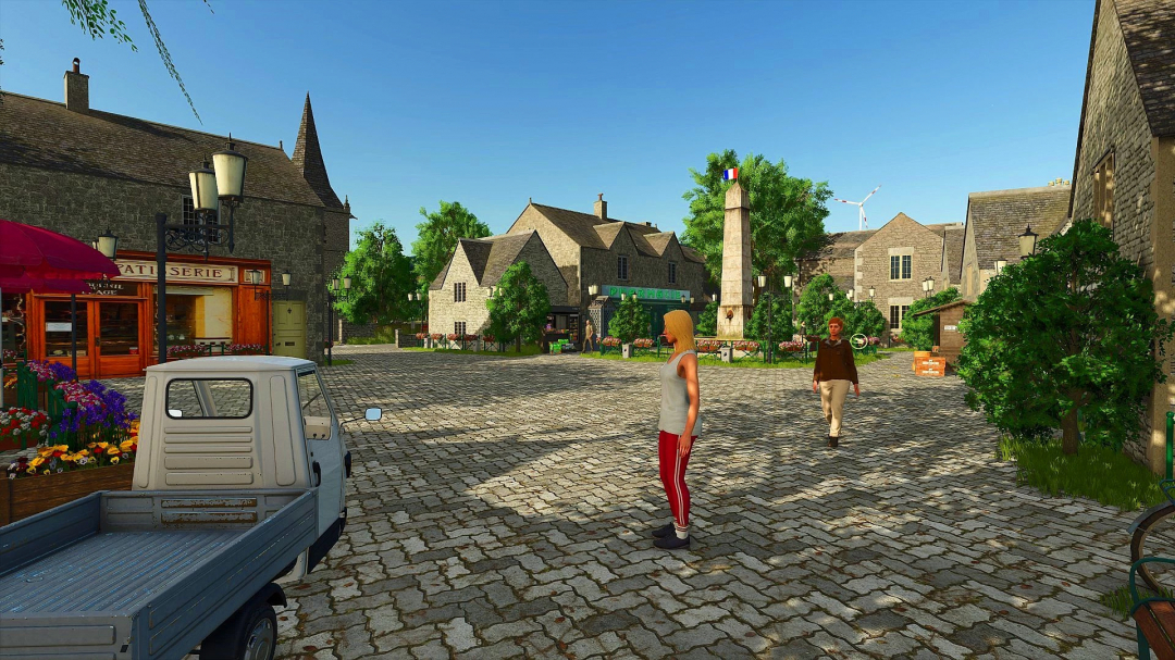 Charming town square in FS25 mod 'Au Fil des Saisons'. Features stone buildings, a patisserie, and lush greenery.