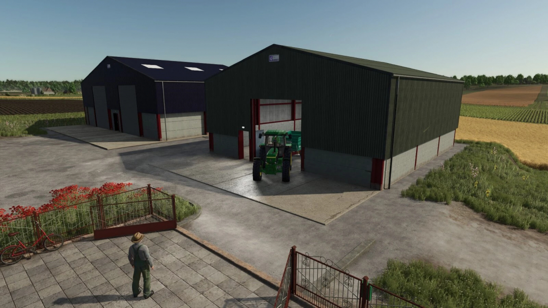 FS25 mod British Grain Sheds v1.0.0.0 with tractor in front, showcasing farm buildings in Farming Simulator 25.