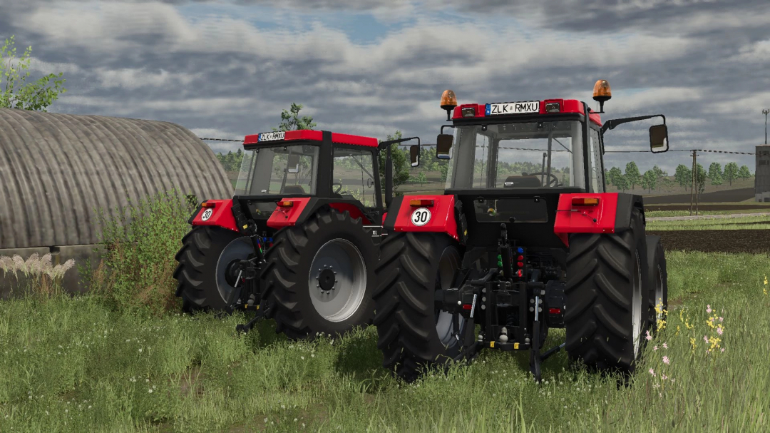 FS25 Case IH 56 Series mod v1.0.0.2 showing two red tractors in a grassy field.