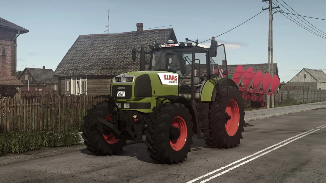 Claas Atles 900RZ tractor mod in FS25 parked on a rural road, showcasing its large tires and robust design.