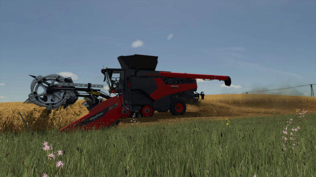 Claas Lexion 8900 harvester in FS25 mod, cutting through a wheat field with a clear sky background.