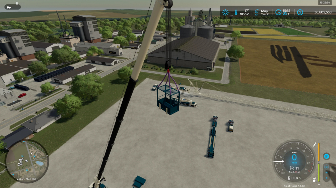 FS22 mod Crane Accessories in use at a construction site, showing crane lifting a large container in Farming Simulator 22.