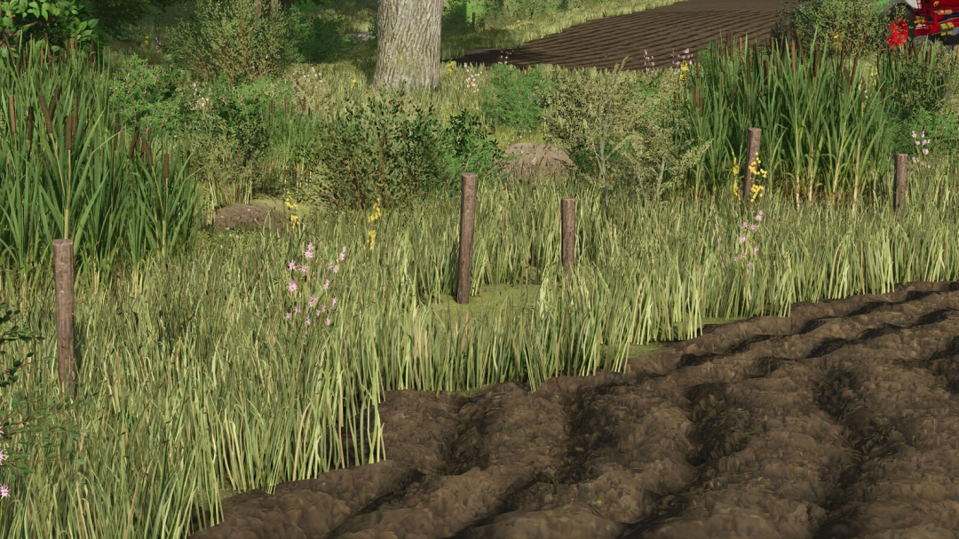 FS25 mod Farm Decoration Pack shows detailed grass and fence near plowed field.