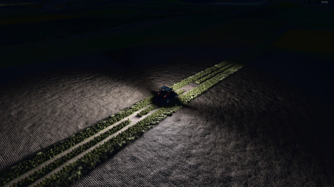 Night scene in FS25 with tractor showing 'Increase Light Range' mod illuminating a field.