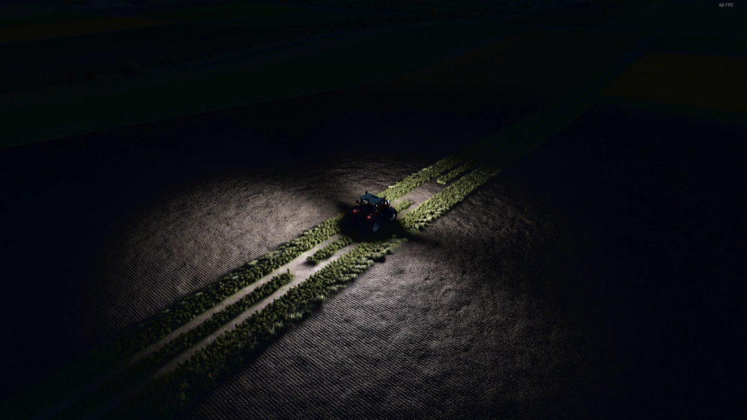 FS25 mod Increase Light Range v1.0.0.0 showing a tractor illuminating farmland at night.