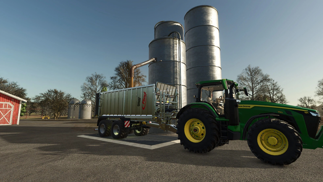 FS25 mod Low Cost Grain Silo v1.0.0.0 with green tractor unloading grain into silo. Farming Simulator 25 mod.