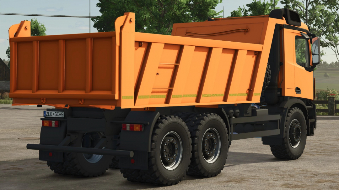 Mercedes Benz Arocs mod in FS25, featuring a bright orange dump truck parked on pavement.