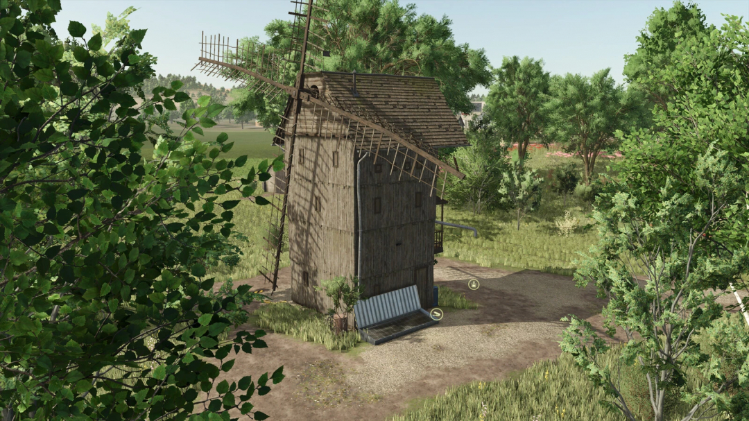 Old Grain Mills mod in Farming Simulator 25 featuring a rustic wooden windmill surrounded by greenery.