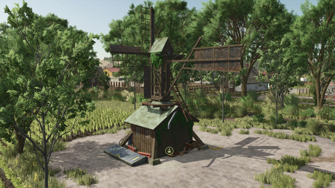 Old grain mill mod in FS25 surrounded by trees and fields, showcasing rustic architecture.