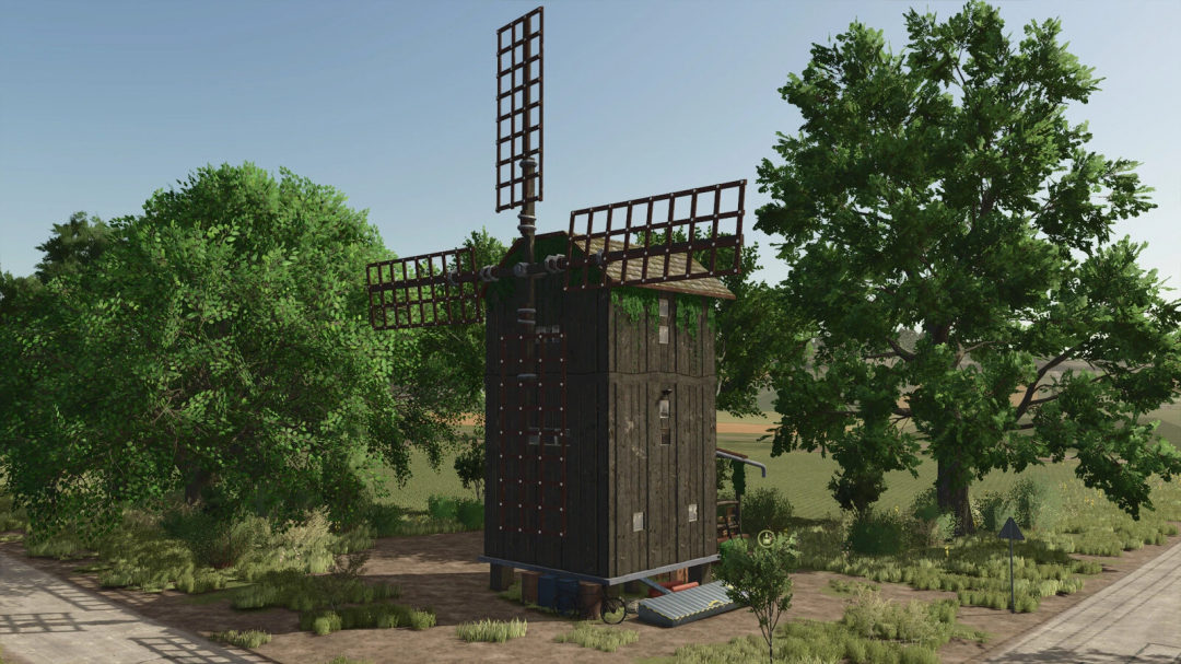 Old grain mill surrounded by trees in FS25, part of Old Grain Mills mod v1.0.0.0.