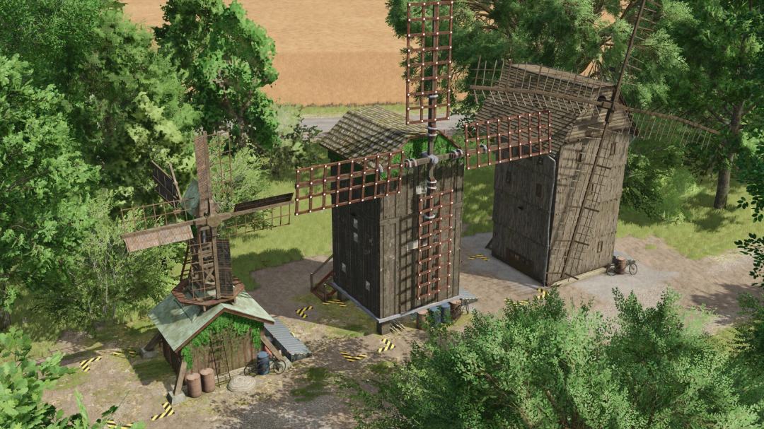 Old grain mills mod in FS25 surrounded by trees, showcasing vintage wooden windmills.