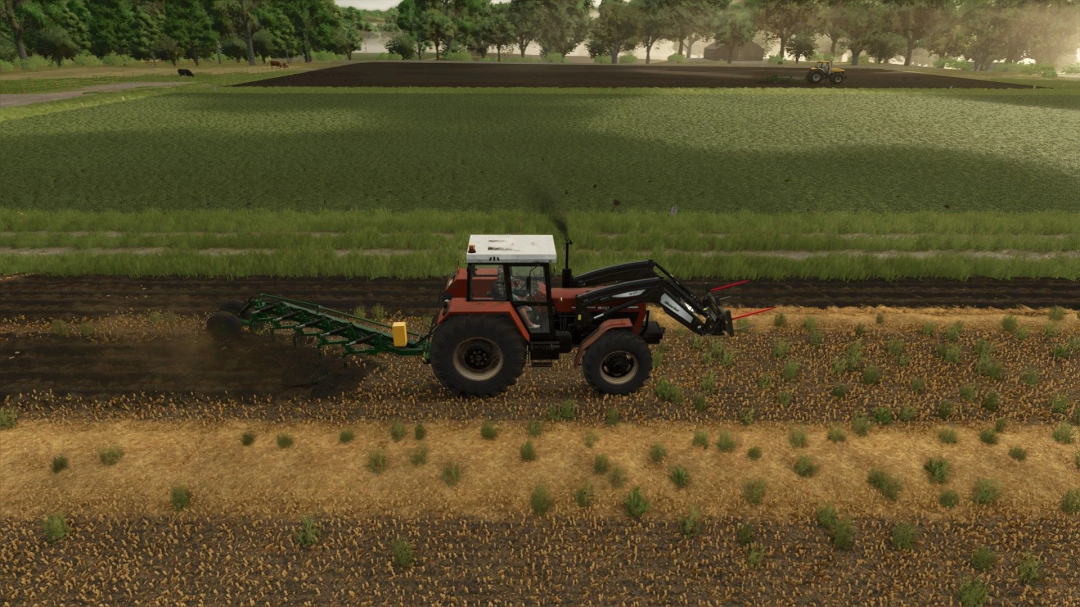 Tractor with front loader in FS25 mod PHX Pack v1.0.0.0, plowing a field with lush green landscape in the background.