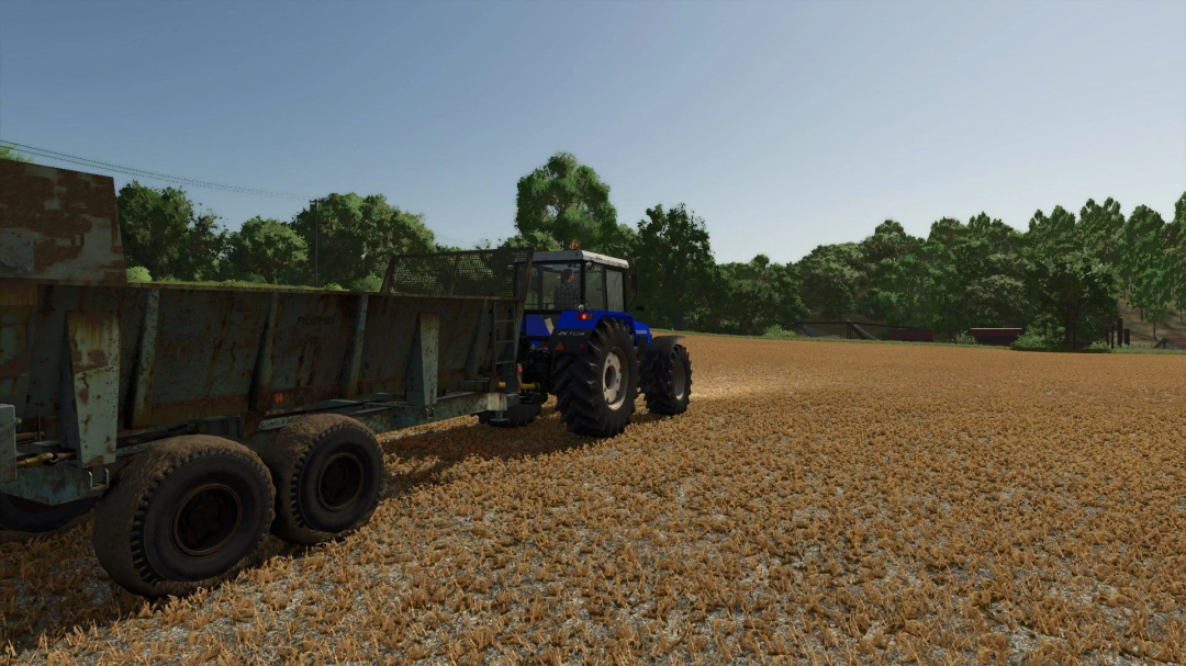 FS25 mod RUR 10 v1.0.0.0 featuring a blue tractor with a rusty trailer on a field.