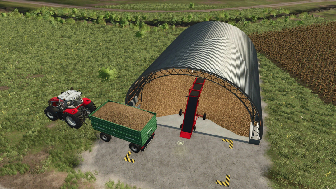 FS25 mod Root Crop Storage v1.0.0.0 showing a tractor and trailer unloading crops into a storage building.