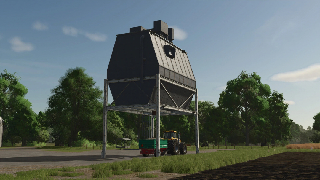 FS25 Stone Silo mod with tractor underneath, set in a farm landscape.