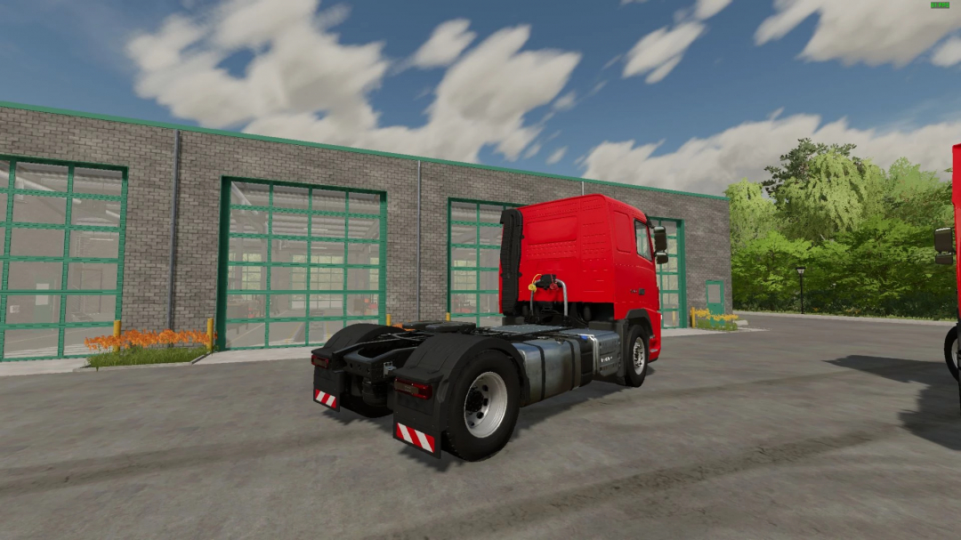 Volvo FH3 truck mod for FS22 parked outside a garage in Farming Simulator 22.