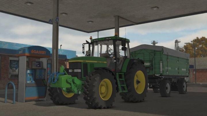 fs25-mods,  FS25 JD 900kg weight mod v1.0.0.0 showing a tractor with a trailer at a gas station in Farming Simulator 25.