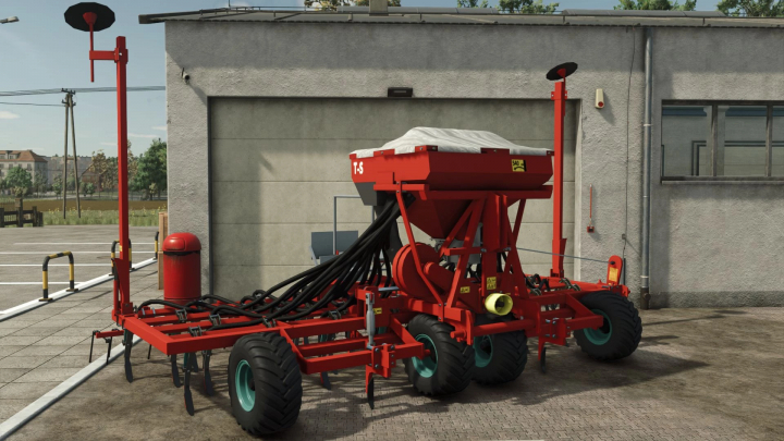 fs25-mods,  Kverneland TS-Drill mod in FS25, showcasing a red seeder near a building.