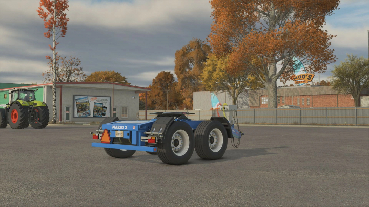 fs25-mods, FS25 mod image: MEGA Mario 2 Dolly v1.0.0.0 in a farmyard setting, with autumn trees and a tractor nearby.