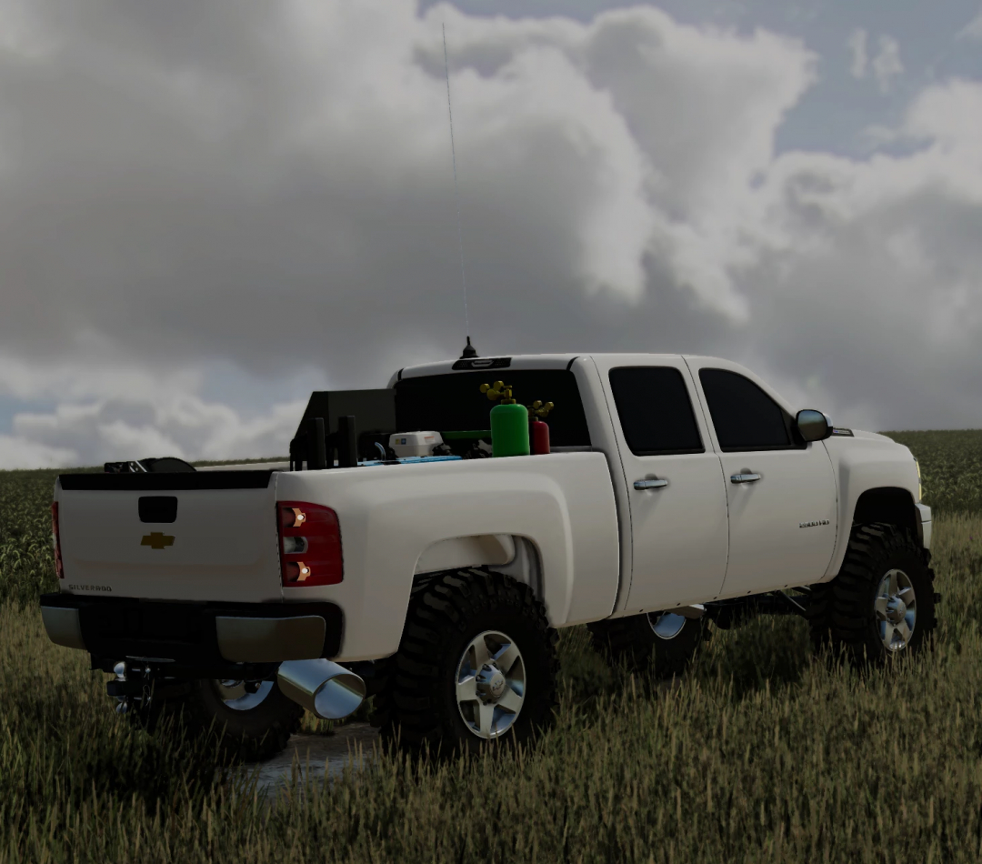 FS22 2010 Duramax 2500 mod featuring a white pickup truck in a field under cloudy skies.