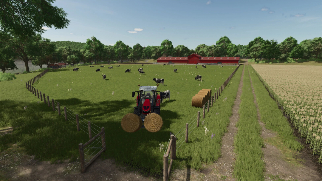 FS25 Cow Barn XL mod showcasing cows grazing with a tractor by hay bales.